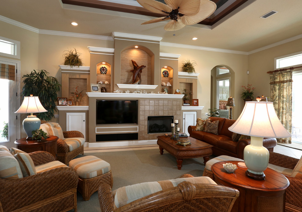 Photo of a medium sized world-inspired open plan living room in Orlando with beige walls, a standard fireplace, a tiled fireplace surround and a built-in media unit.