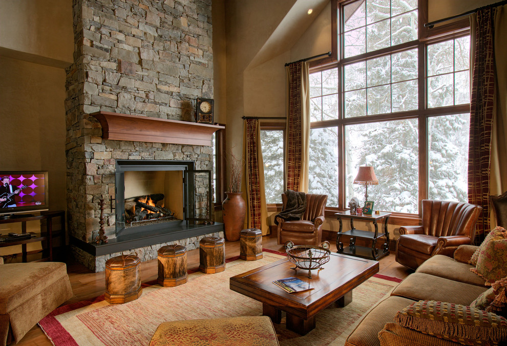 Classic living room in Denver with beige walls, a standard fireplace and a freestanding tv.
