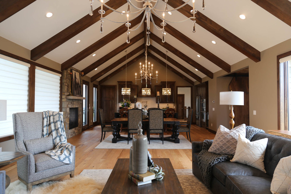 Inspiration for a mid-sized timeless open concept light wood floor and beige floor living room remodel in Other with gray walls, a two-sided fireplace, a stone fireplace and a wall-mounted tv