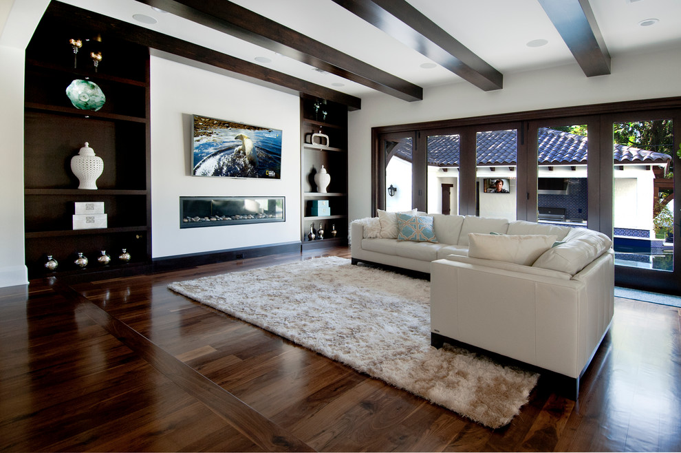 Large transitional open concept dark wood floor living room photo in Tampa with white walls, a ribbon fireplace and a wall-mounted tv