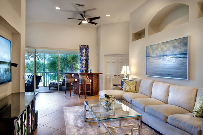 Traditional open plan living room in Tampa with beige walls and a wall mounted tv.
