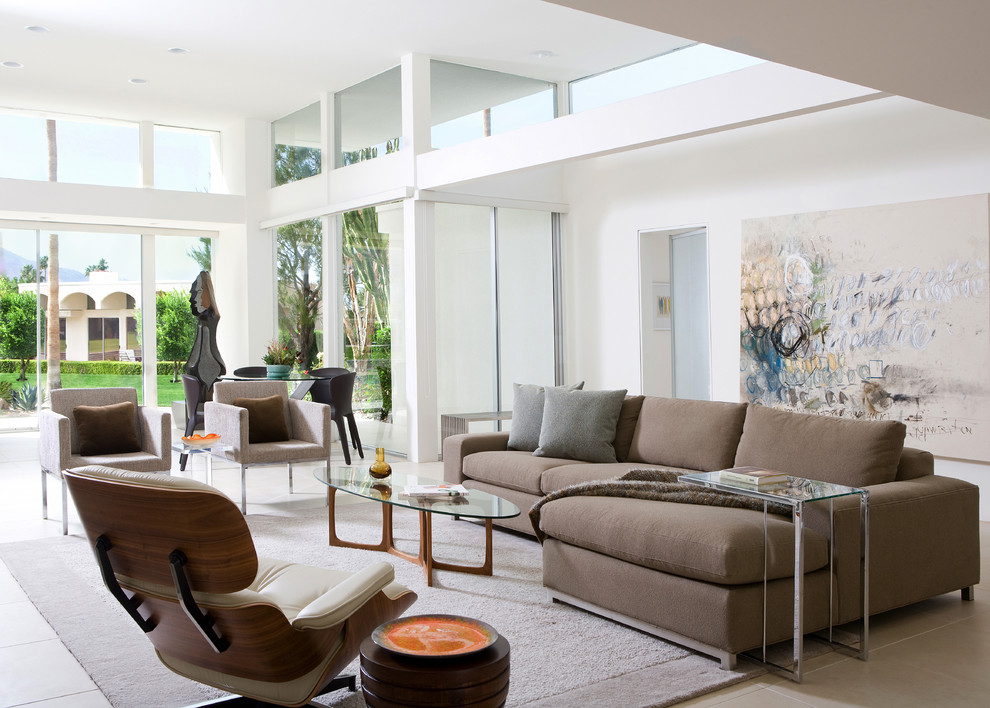 Large contemporary formal open plan living room in Los Angeles with white walls, no tv and beige floors.