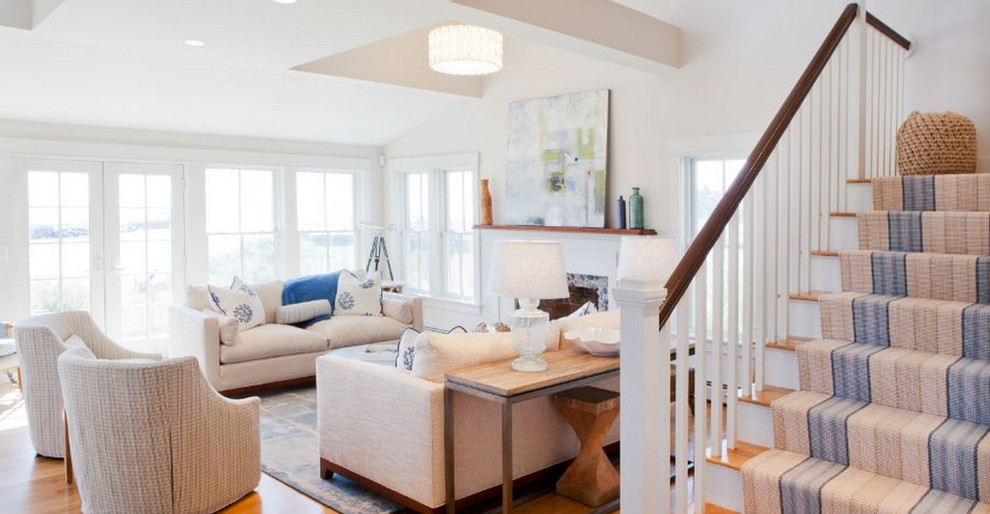 Example of a mid-sized beach style open concept light wood floor living room design in Boston with beige walls, a standard fireplace, a stone fireplace and no tv