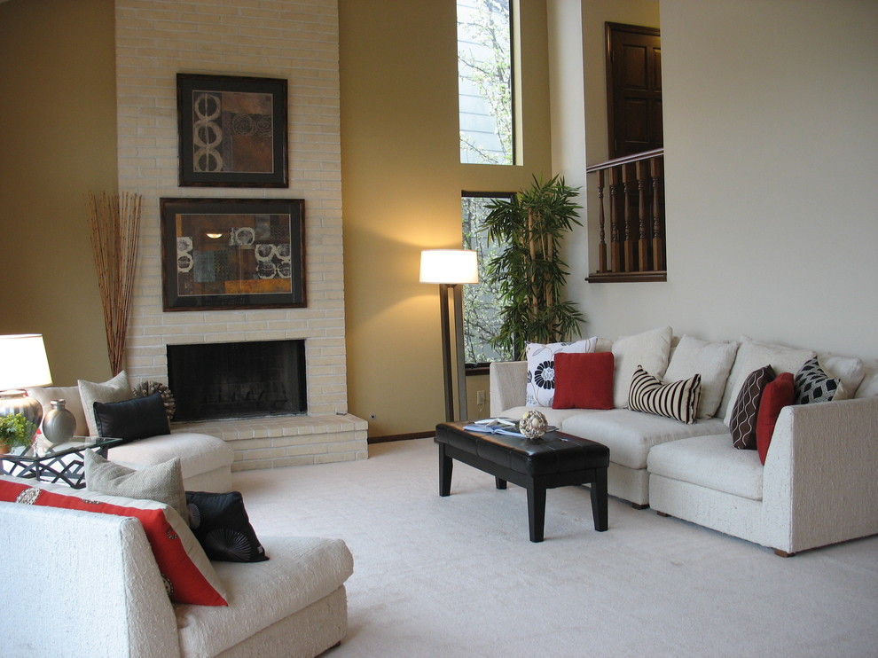 Inspiration for a mid-sized timeless formal and enclosed carpeted living room remodel in San Francisco with yellow walls, a standard fireplace, a brick fireplace and no tv