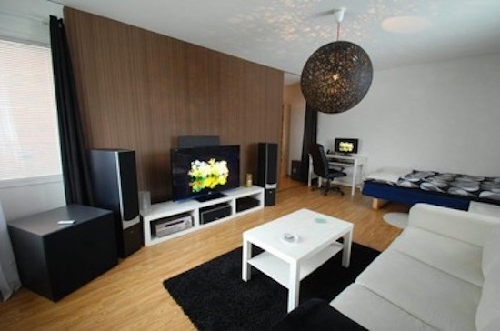 Mid-sized trendy enclosed light wood floor living room photo in Portland with white walls, no fireplace and a tv stand