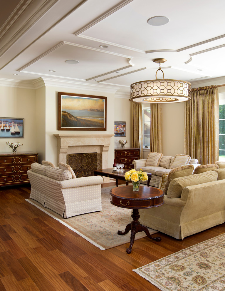 Example of a mid-sized classic open concept medium tone wood floor living room design in San Francisco with beige walls, a standard fireplace, a stone fireplace and no tv
