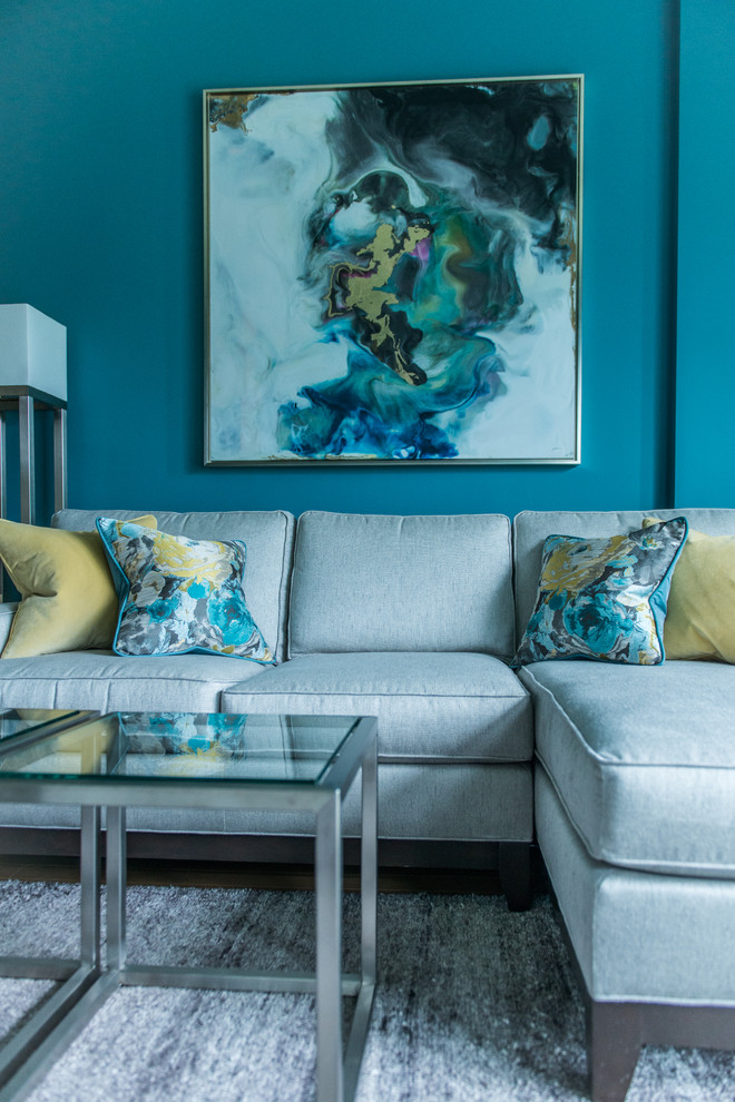 Inspiration for a medium sized modern grey and teal mezzanine living room in DC Metro with blue walls, light hardwood flooring, a standard fireplace, a wooden fireplace surround, a built-in media unit and yellow floors.