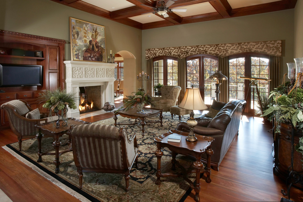 Photo of an open plan living room in Milwaukee with a standard fireplace, a brick fireplace surround, green walls and dark hardwood flooring.