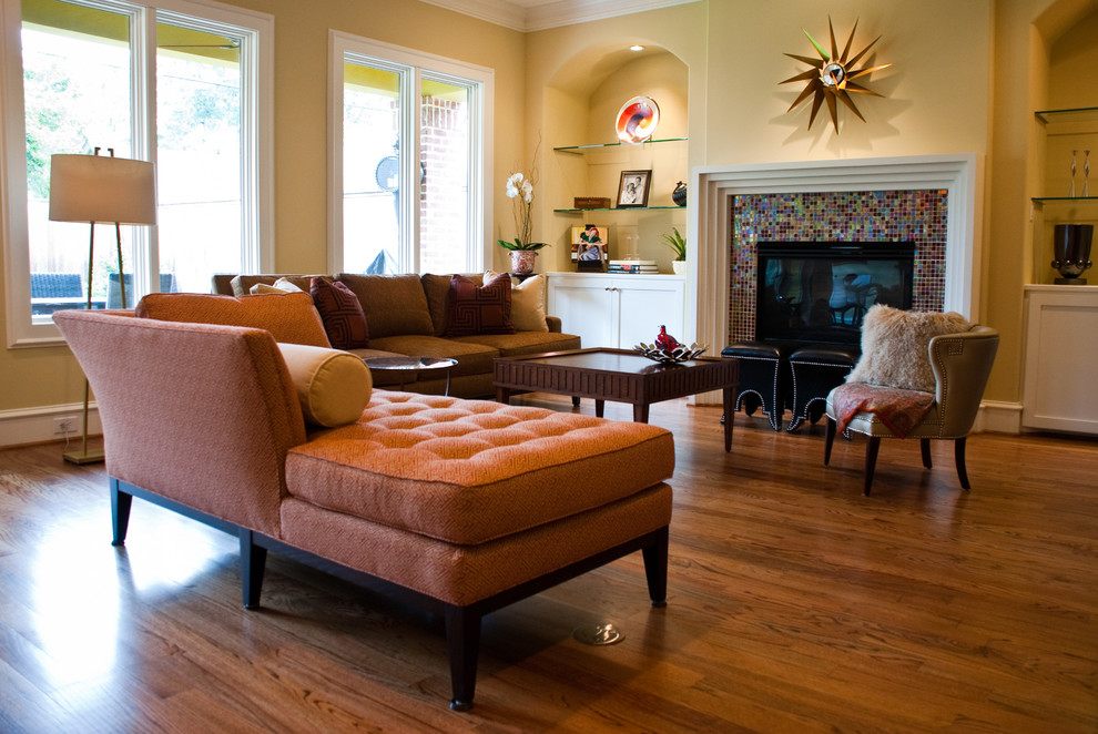 Inspiration pour un salon design ouvert avec un mur beige, un sol en bois brun, une cheminée standard, un manteau de cheminée en carrelage et un téléviseur indépendant.