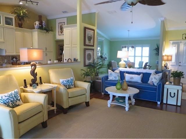 Living room - mid-sized coastal formal and enclosed medium tone wood floor and brown floor living room idea in Orlando with no tv, yellow walls and no fireplace