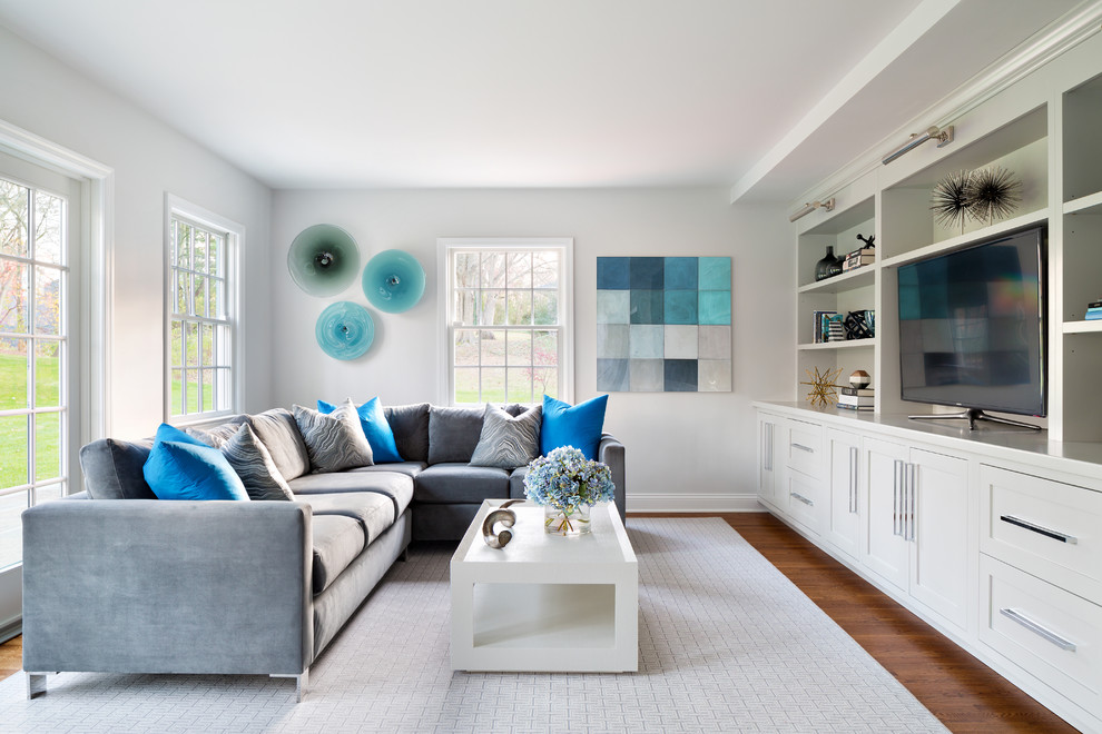 Living room - mid-sized transitional formal medium tone wood floor living room idea in New York with white walls and a tv stand