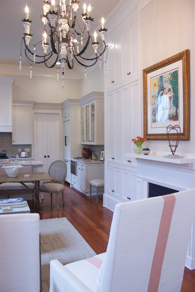 This is an example of a medium sized traditional living room in New Orleans with white walls and light hardwood flooring.