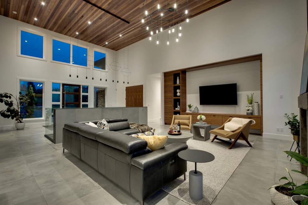 Living room - large modern open concept ceramic tile and gray floor living room idea in Calgary with white walls, a standard fireplace, a metal fireplace and a media wall