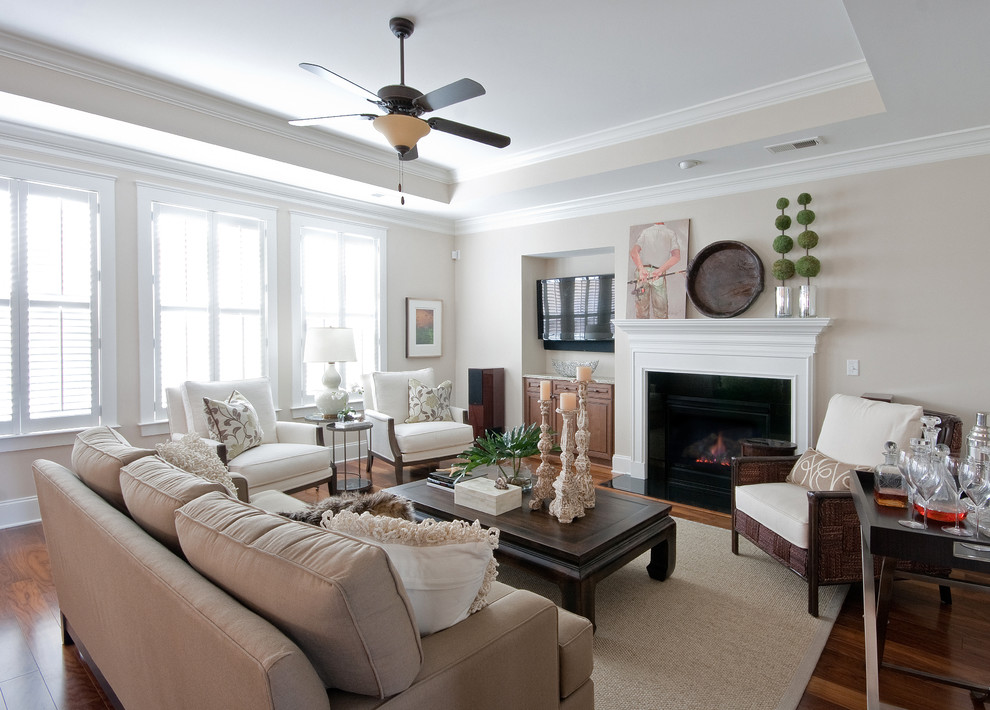 Living room - traditional living room idea in Charleston with beige walls and a standard fireplace
