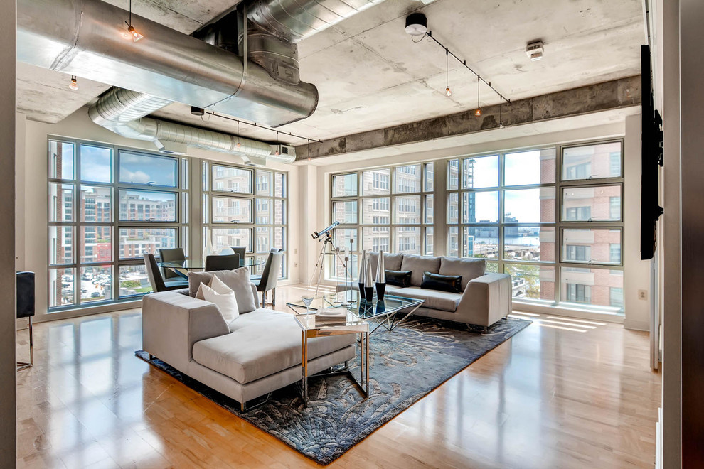 Example of an urban formal and open concept light wood floor living room design in Baltimore with a wall-mounted tv