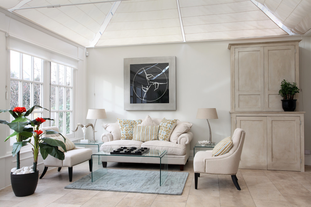 Example of a transitional beige floor living room design in Sussex with white walls