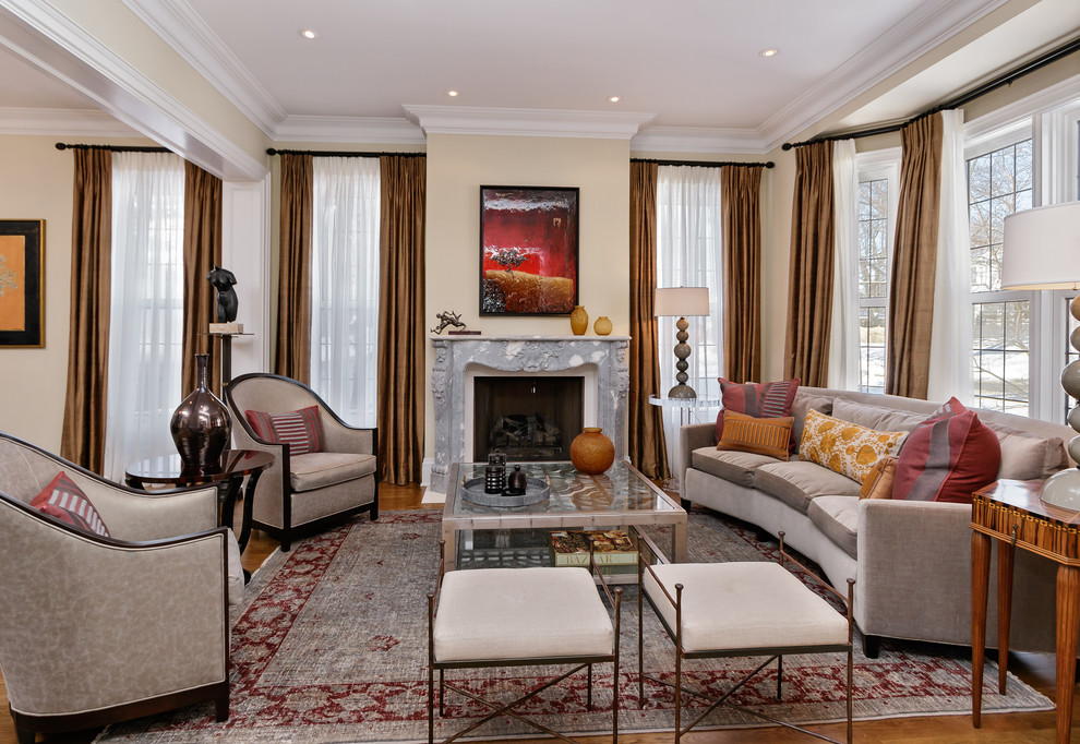 This is an example of a large contemporary open plan living room in Toronto with beige walls, a stone fireplace surround, a standard fireplace and medium hardwood flooring.
