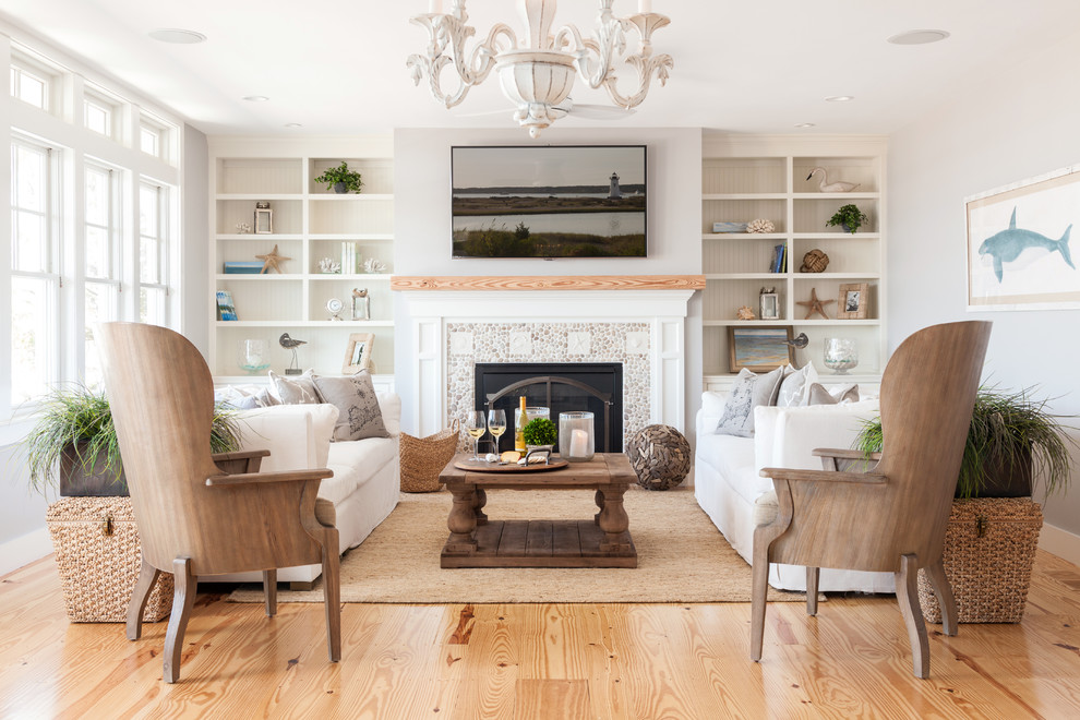 Design ideas for a large beach style formal enclosed living room in Boston with light hardwood flooring, a standard fireplace, a stone fireplace surround, grey walls and no tv.