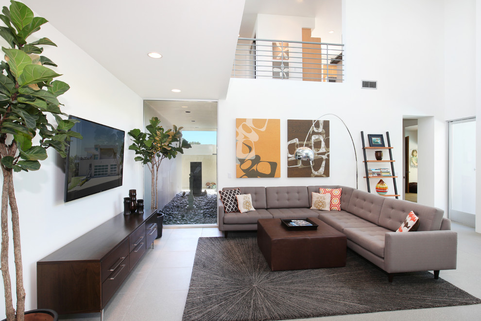 Inspiration for a mid-sized tropical living room remodel in Orange County with white walls