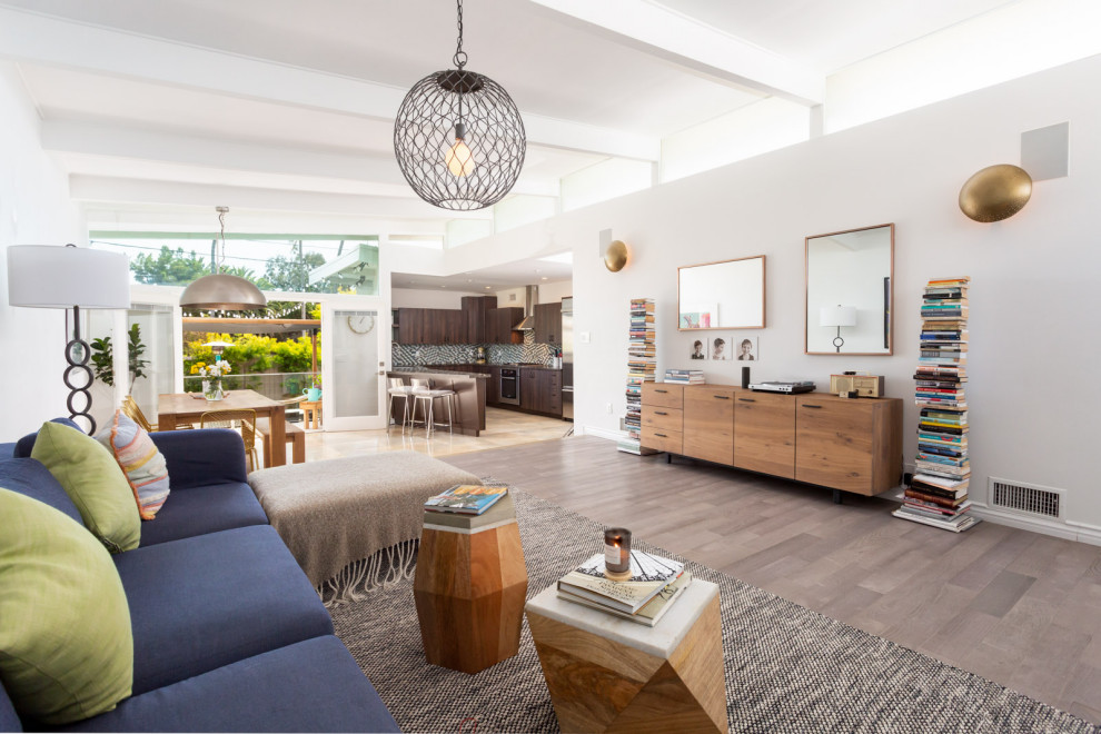 Living room - mid-sized 1950s open concept light wood floor, gray floor and exposed beam living room idea in Los Angeles with white walls and a corner fireplace