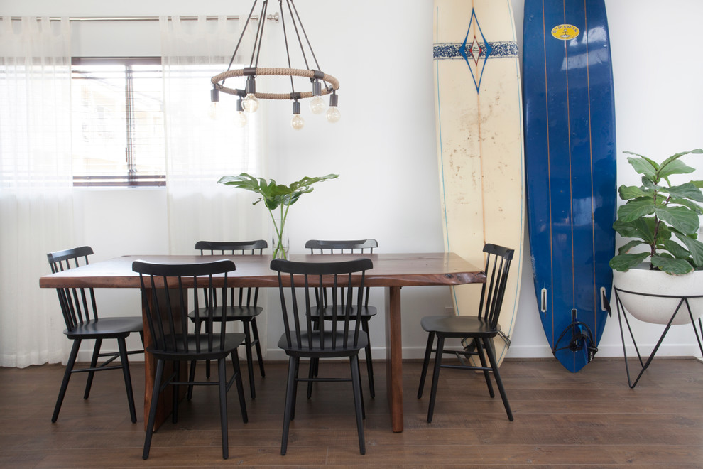 Photo of a medium sized nautical dining room in Los Angeles with white walls, dark hardwood flooring and no fireplace.