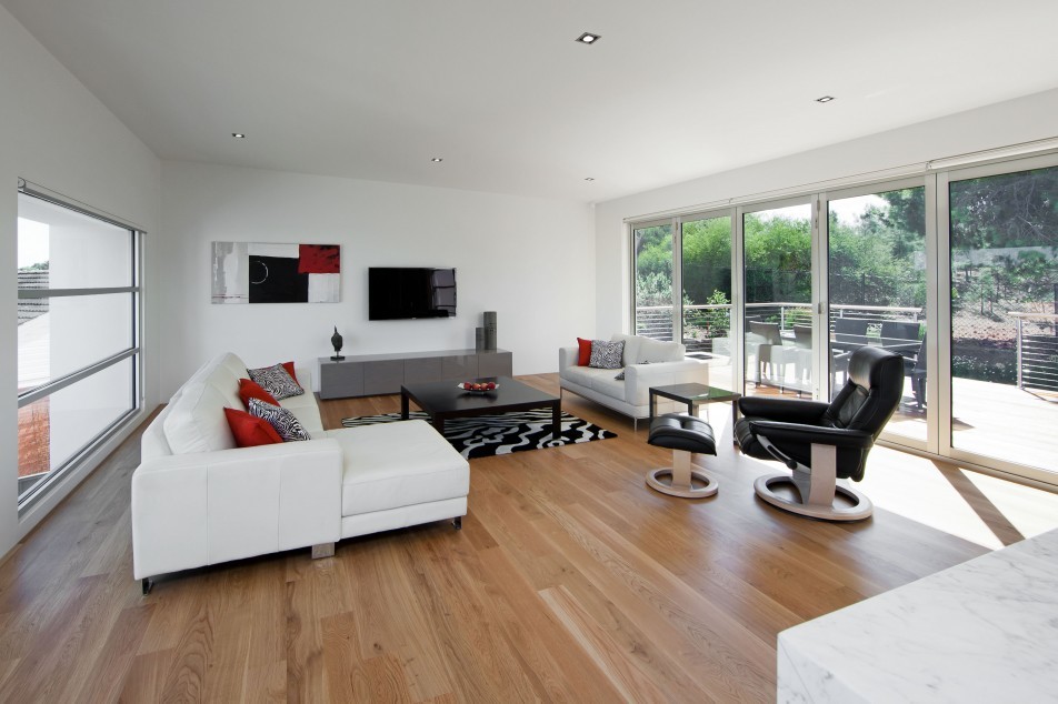 Inspiration for a medium sized modern open plan living room in Adelaide with white walls, light hardwood flooring, no fireplace and a wall mounted tv.