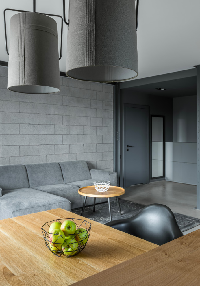 Стильный дизайн: гостиная комната в стиле лофт с фасадом камина из бетона - последний тренд