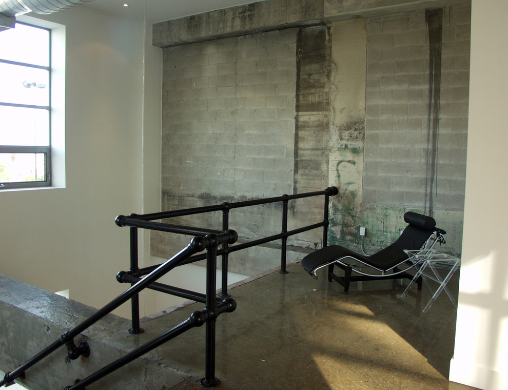 Living room - industrial concrete floor living room idea in Toronto
