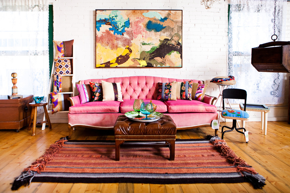 Inspiration for an eclectic medium tone wood floor living room remodel in Denver with white walls