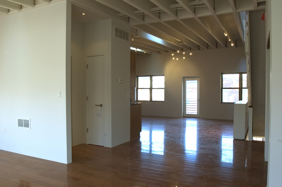 Example of a mid-sized urban loft-style concrete floor living room design in Philadelphia with white walls, no fireplace and no tv