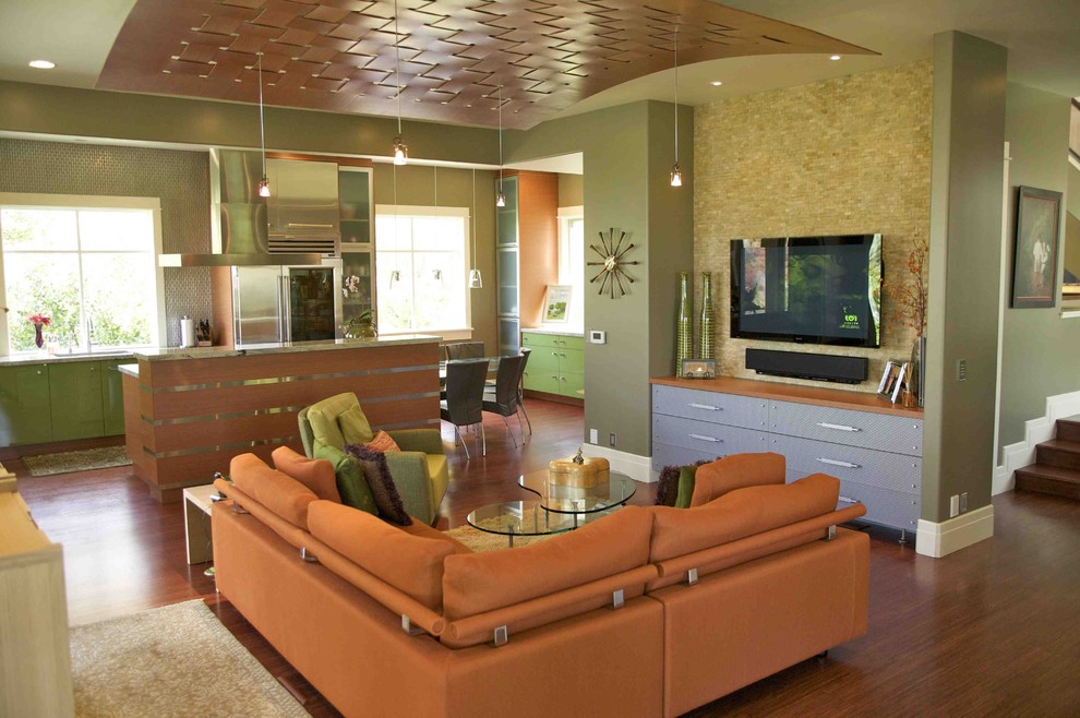 Small trendy open concept medium tone wood floor living room photo in Salt Lake City with a wall-mounted tv and green walls