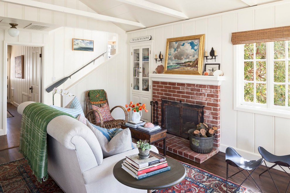 Inspiration for a small coastal formal and enclosed dark wood floor living room remodel in Orange County with white walls, a standard fireplace, a brick fireplace and no tv
