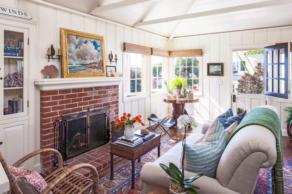 Example of a small beach style formal and enclosed dark wood floor living room design in Orange County with white walls, a standard fireplace and a brick fireplace