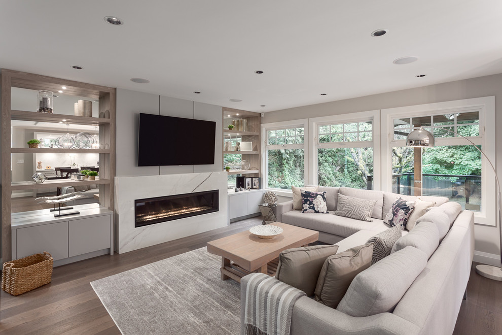 Design ideas for a large contemporary open plan living room in Vancouver with grey walls, dark hardwood flooring, a ribbon fireplace, a tiled fireplace surround, a wall mounted tv and brown floors.