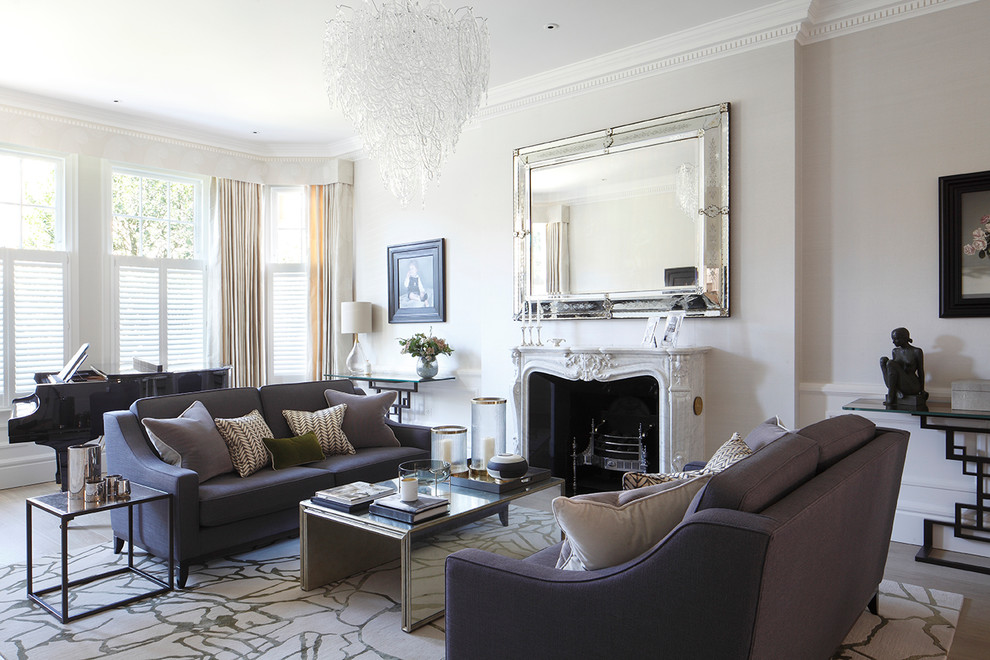 Photo of a traditional formal living room in London with white walls, light hardwood flooring, a standard fireplace, no tv and beige floors.