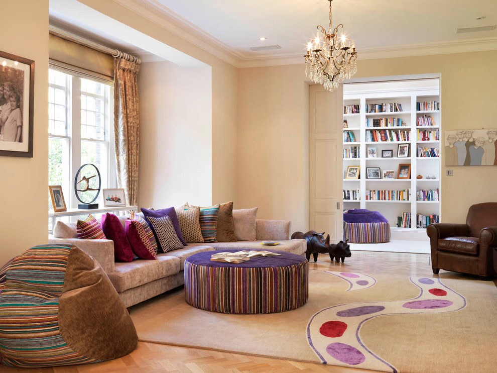 This is an example of a contemporary enclosed living room in London with a reading nook and beige walls.