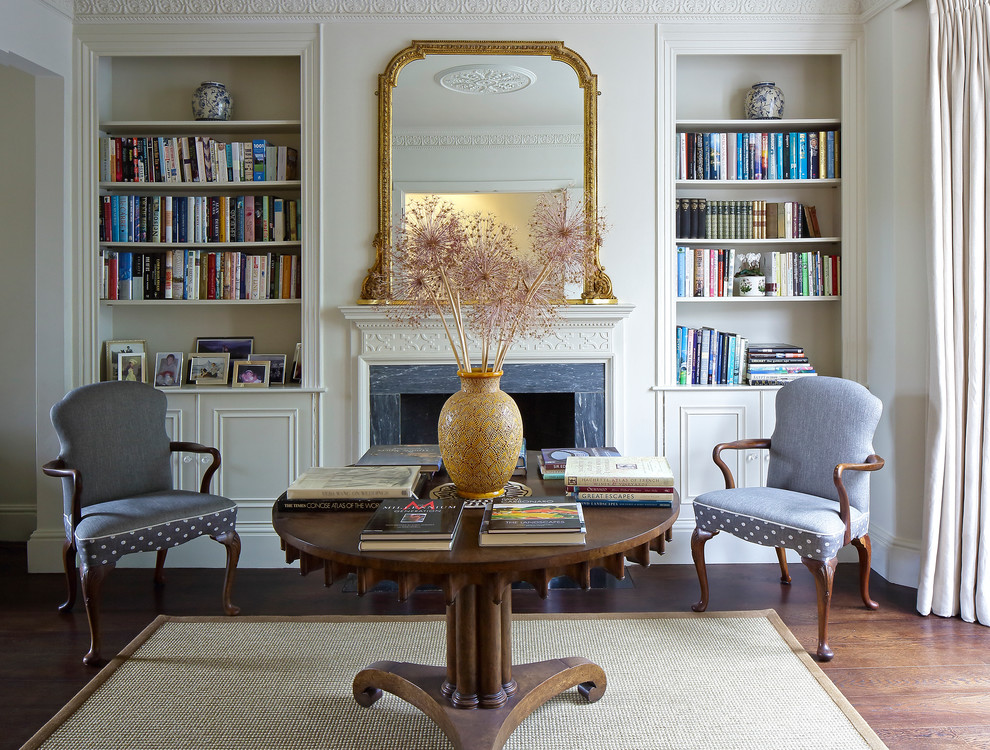 Living room - victorian dark wood floor living room idea in London with a standard fireplace and a stone fireplace