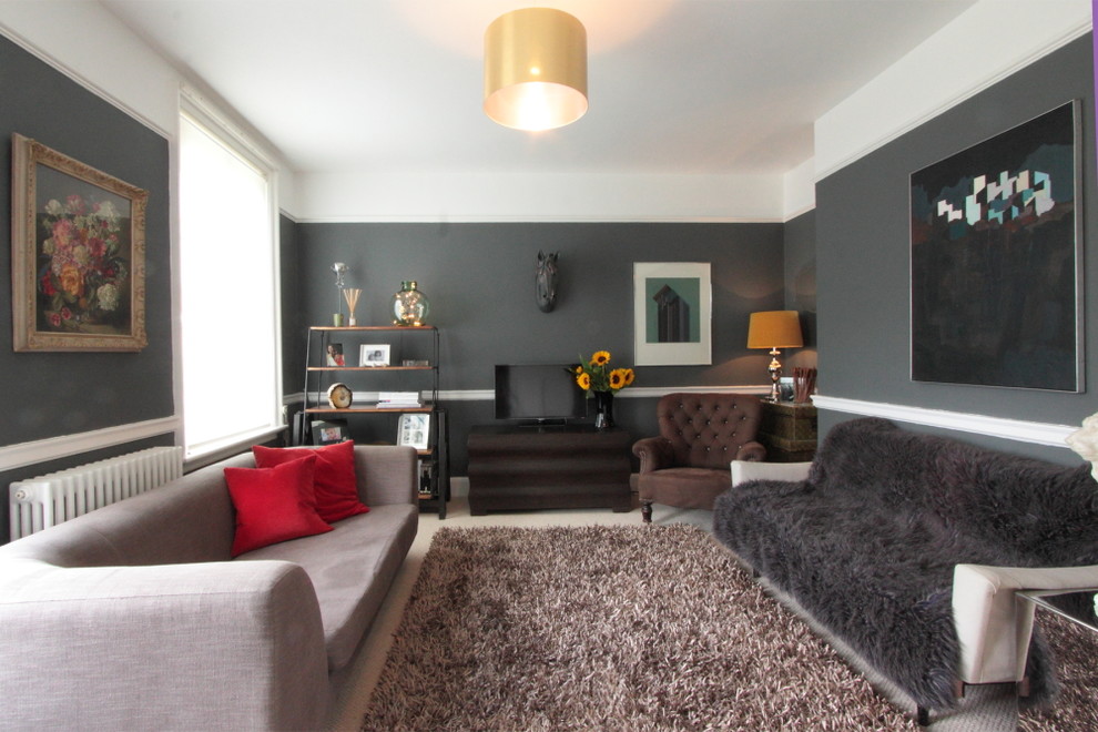 Trendy enclosed living room photo in London with gray walls and a tv stand