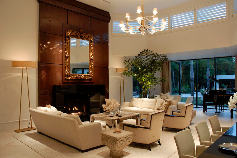 Large contemporary formal open plan living room in Miami with white walls, limestone flooring, a standard fireplace and no tv.