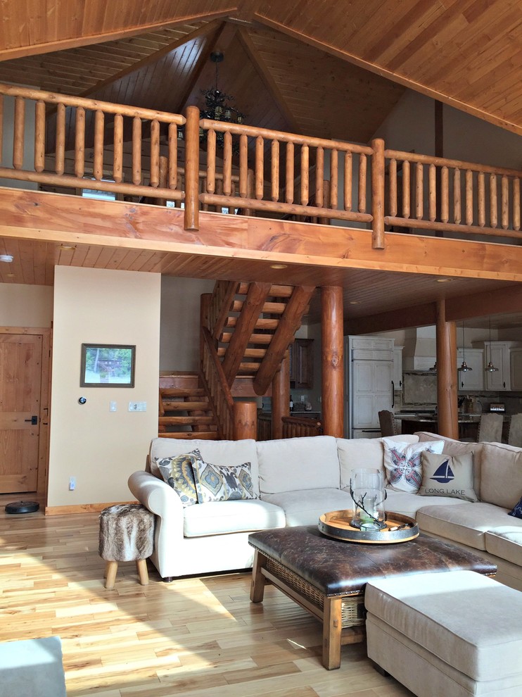 Photo of a large classic formal open plan living room in Other with light hardwood flooring, a standard fireplace, a stone fireplace surround and a wall mounted tv.