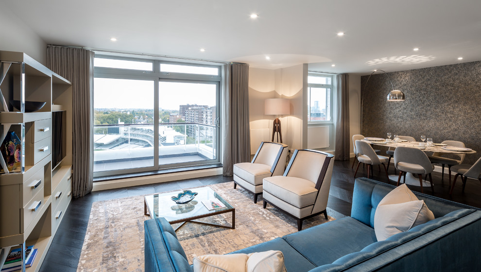 Contemporary open plan living room in London with beige walls, dark hardwood flooring and a wall mounted tv.