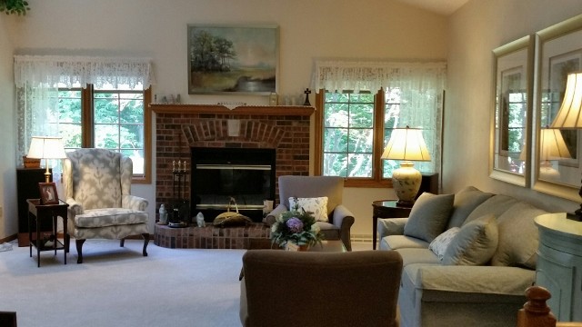 Aménagement d'un salon classique de taille moyenne et fermé avec un mur beige, une cheminée standard et un manteau de cheminée en brique.