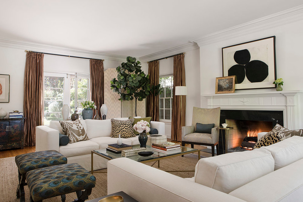 Example of a classic formal medium tone wood floor living room design in Los Angeles with white walls and a standard fireplace