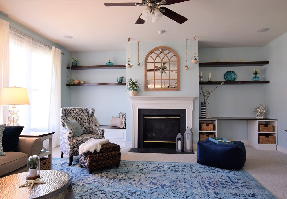 Imagen de salón abierto marinero de tamaño medio con paredes azules, moqueta, todas las chimeneas, marco de chimenea de madera y televisor colgado en la pared
