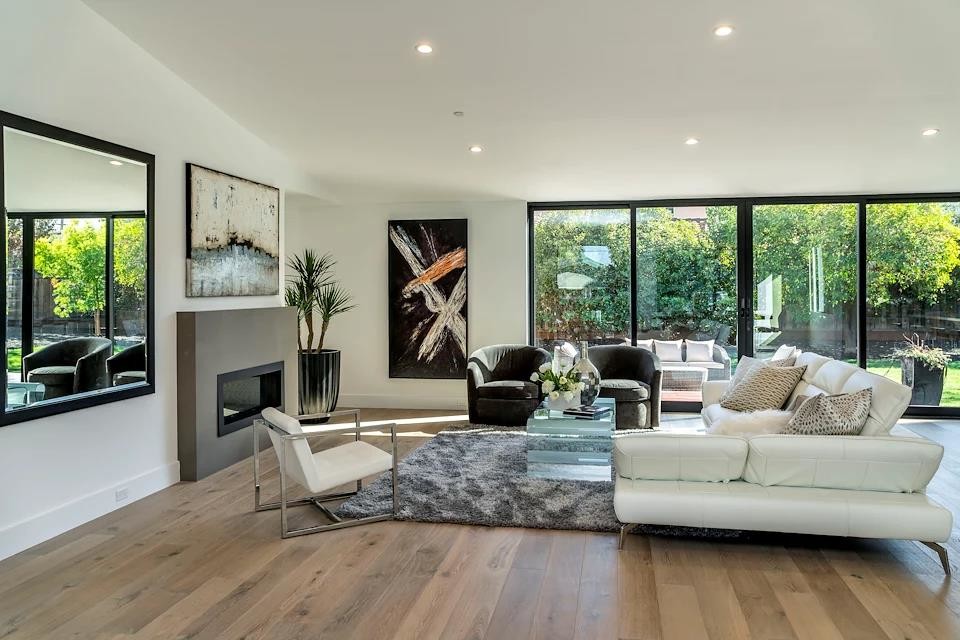 Inspiration for a mid-sized modern formal and open concept light wood floor and beige floor living room remodel in San Francisco with white walls, a ribbon fireplace, a plaster fireplace and no tv