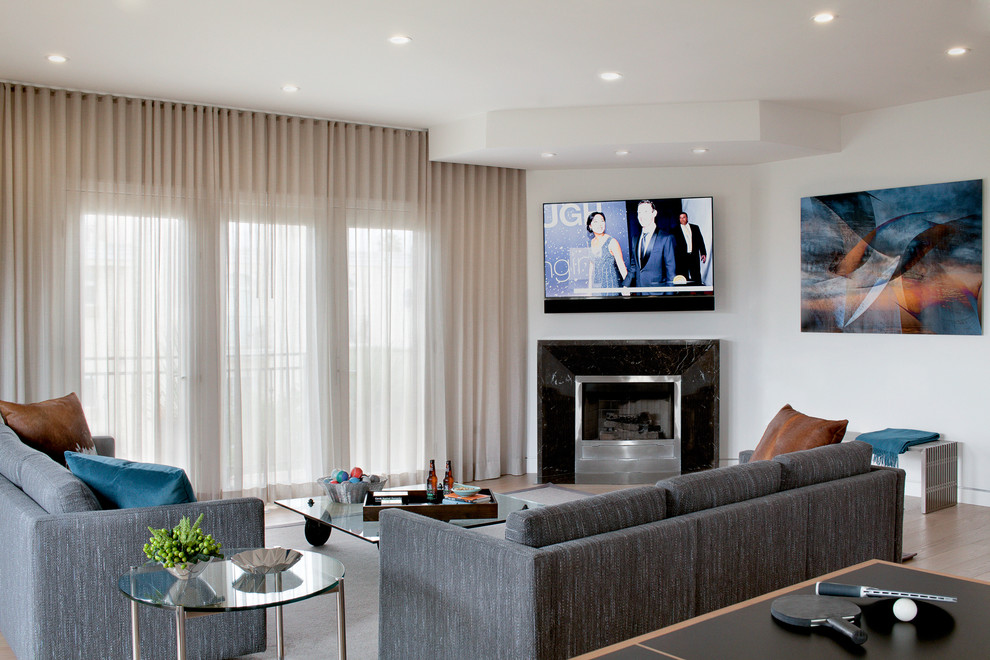 Living room - contemporary living room idea in Los Angeles with a corner fireplace