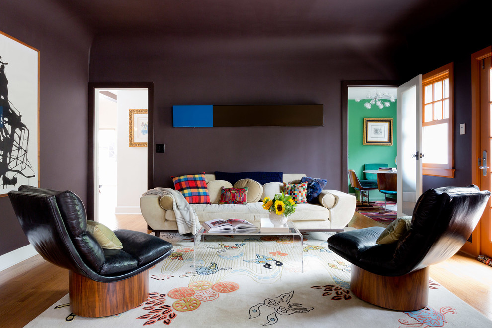 Example of a trendy medium tone wood floor and brown floor living room design in Other with purple walls