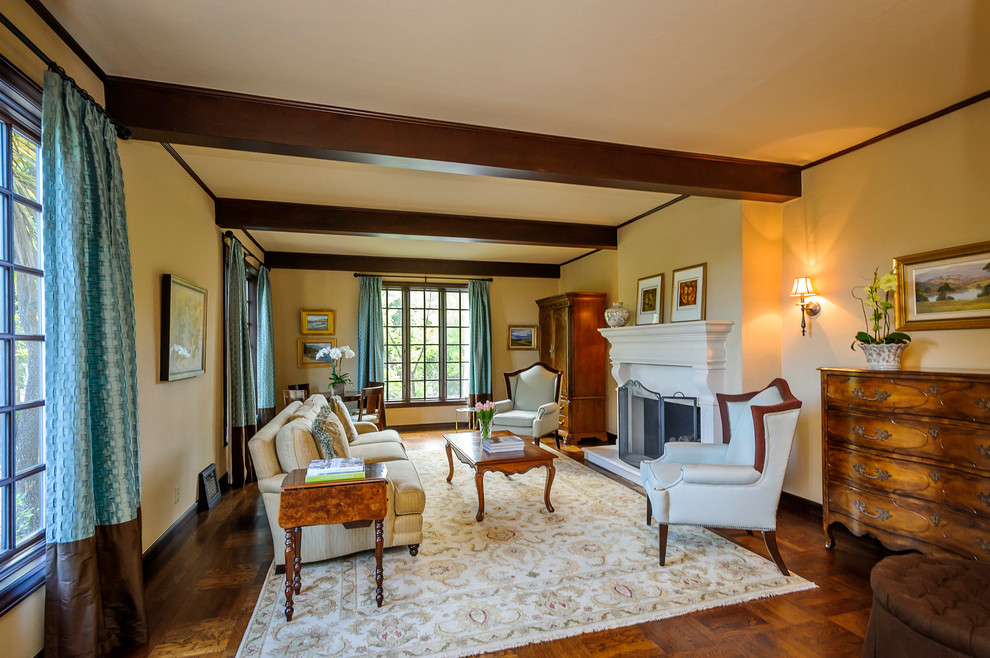 Ejemplo de salón para visitas cerrado clásico de tamaño medio con paredes beige, suelo de madera en tonos medios, todas las chimeneas y marco de chimenea de piedra