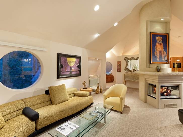 Kleines, Fernseherloses, Offenes Modernes Wohnzimmer mit beiger Wandfarbe, Teppichboden, Tunnelkamin und Kaminumrandung aus Stein in Denver
