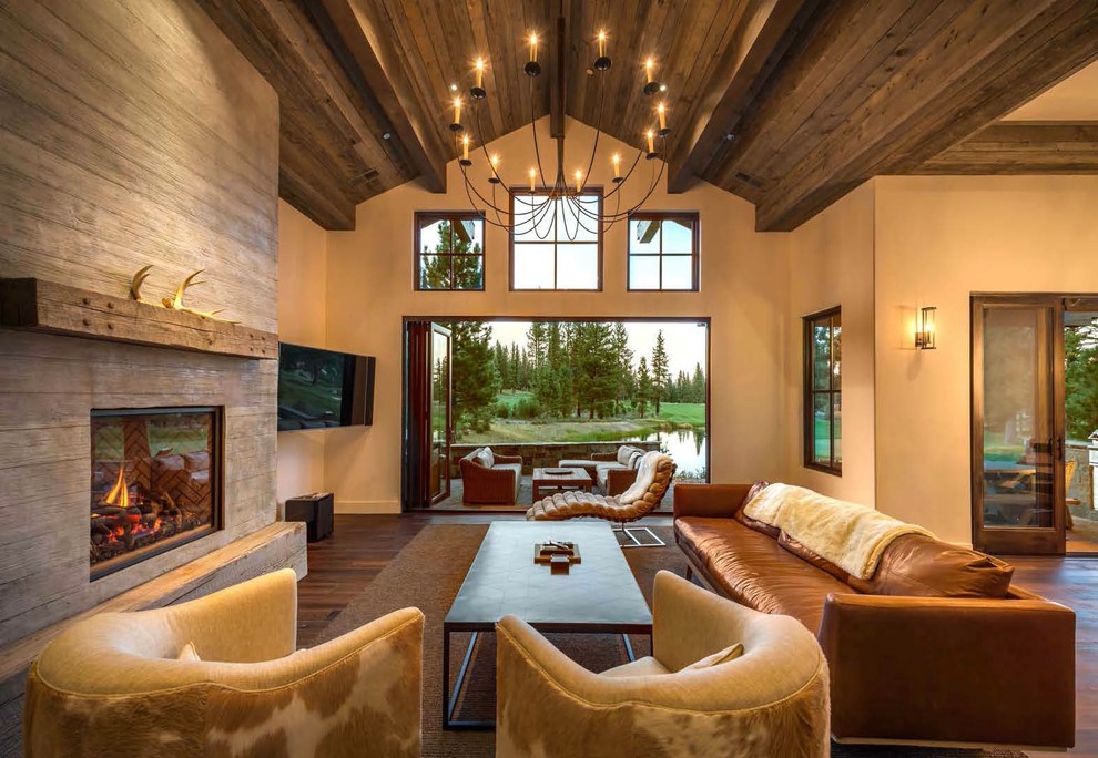 Rustic formal living room in Sacramento with beige walls, dark hardwood flooring, a standard fireplace, a wooden fireplace surround and a wall mounted tv.